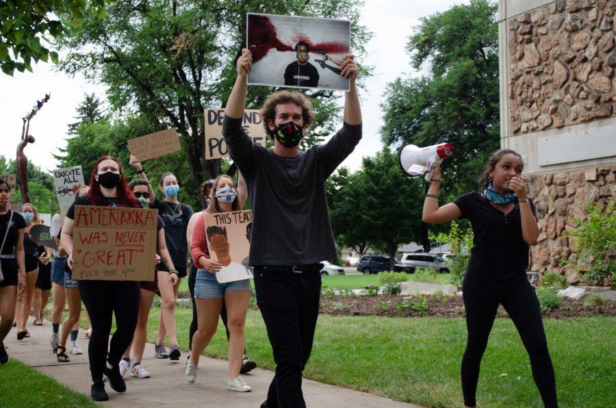 Roesler and Wilson lead the march and chants with a megaphone. (Reed Slater | Collegian)