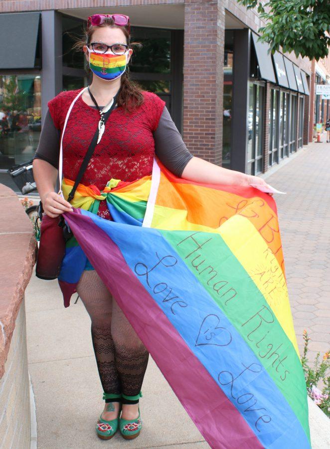 Jenni Herrick poses with her rainbow flag before the start of the second annual Northern Colorado Pride March July 17, 2020 in Old Town Fort Collins. (Serena Bettis | The Collegian)