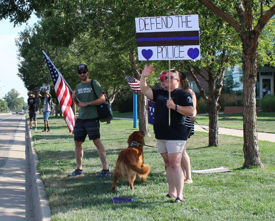 Demonstrators hold signs in support of the police outside the Fort Collins Police Services station on Timberline Road Saturday, Aug. 8, 2020. Violence broke out between groups of protesters and counter protesters earlier in the day that resulted in five arrests by FCPS.(Serena Bettis | The Collegian)