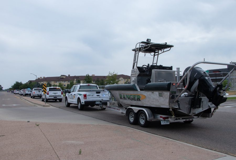 A Larimer County Ranger truck tows a boat down Drake Road as part of the memorial procession honoring Larimer County Department of Natural Resources Ranger, veteran and Colorado State University alum Brendan Unitt Aug. 28. Unitt died at Hoorsetooth Reservoir while on duty Aug. 20. Cause of death is currently under investigation. (Anna von Pechmann | The Collegian) 

