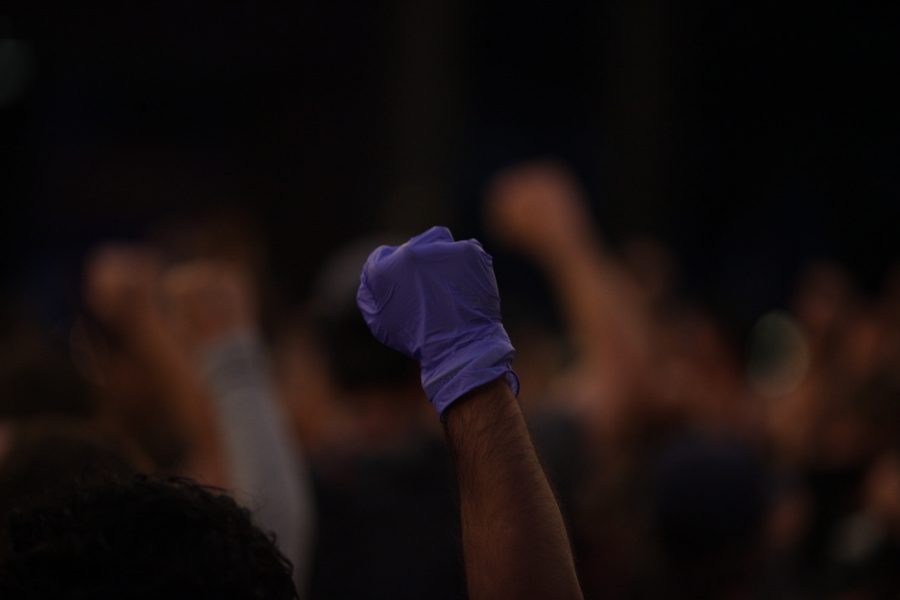 A protester holds up a gloved hand in Old Town Square on Aug 28. Protesters gathered on the anniversary of the March on Washington and marched for racial justice on the CSU campus, in the local community, and throughout the nation. (Ryan Schmidt | The Collegian)