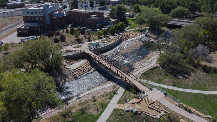 People hangout at the Poudre River Whitewater park during the day. The Park sits right next to the CSU Powerhouse Energy Campus. Visitors can swim and tube down the rapids. (Devin Cornelius | Collegian)