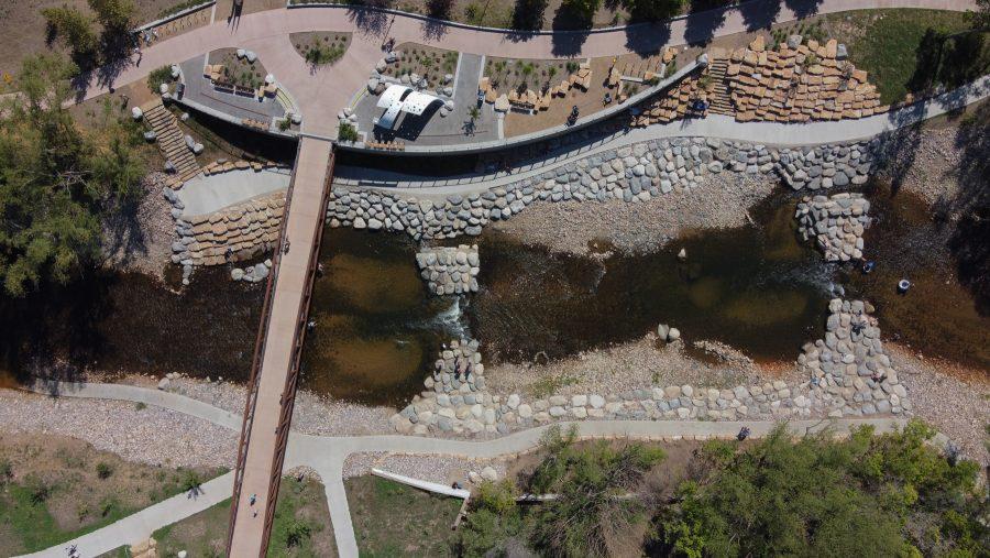 People hangout at the Poudre River Whitewater park during the day. The Park sits right next to the CSU Powerhouse Energy Campus. Visitors can swim and tube down the rapids. (Devin Cornelius | Collegian)