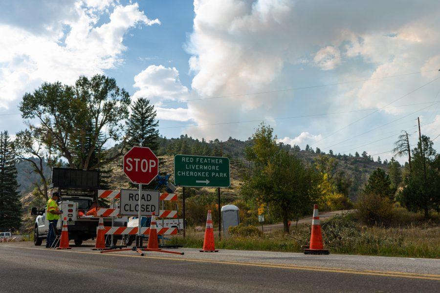 The Poudre Canyon Road is closed at the town of Rustic due to the encroaching Cameron Peak Fire. Smoke plumes can be seen in the background as CDOT workers maintain the road closure and help to regulate traffic. The fire has grown to almost 105,000 acres and remains at 15% containment. (Skyler Pradhan | The Collegian)