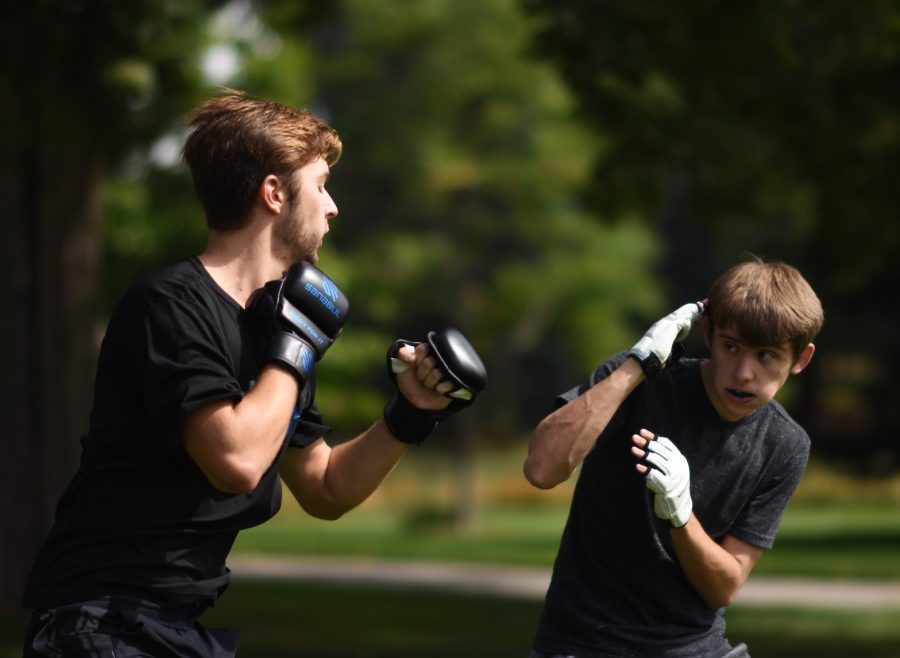 Freshmen Caden Cope and Ryan Higman practice Jeet Kune Do outside the Student Recreation Center Sept. 24, 2020. Cope, a third-generation Bruce Lee student, practices this version of martial arts to keep his “skill sharp, create agility, and form structure,” so he will be prepared for any situation in a fight. (Tri Duong | The Collegian)