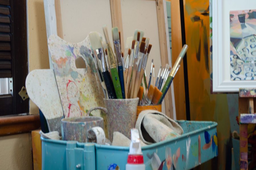 Parker has several cups full of brushes in her studio. (Reed Slater | Collegian)