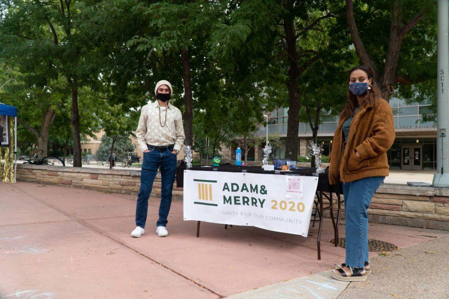Adam and Merry stand in front of their table on the Plaza. (Ben Leonard | The Collegian)