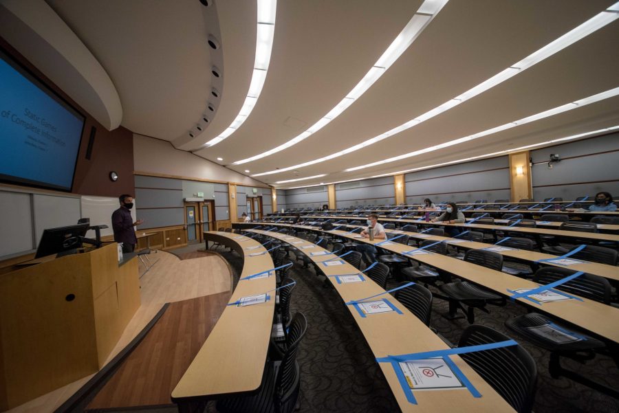 A professor teaches in a large classroom with clearly marked seats for students to ensure social distancing Sept. 1, 2020.