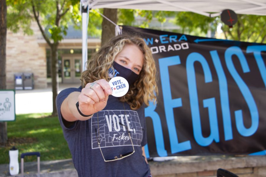 Emma Marion with New Era Colorado shows off her Vote F*cker Pin (Bella Johnson | The Collegian)