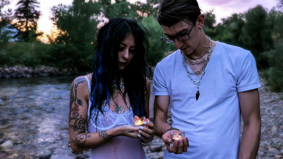 Cheyenne Duba and Steve Welhaf of TARO hold candles in their palms and look at them. (Photo courtesy of TARO)