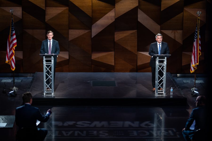 Former Colorado Gov. John Hickenlooper and Sen. Cory Gardner wait for moderator Kyle Clark to finish asking a question before they respond Oct. 13. (Lucy Morantz | The Collegian) 
