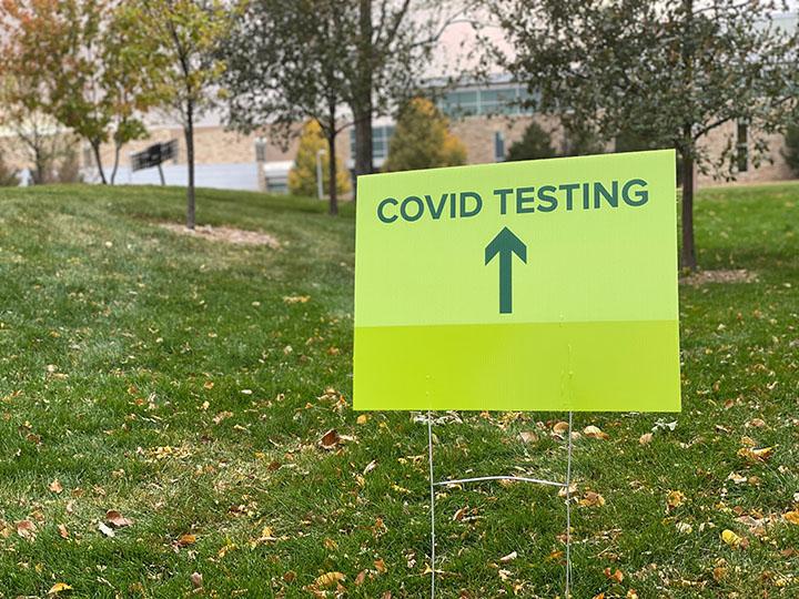 Signs outside of the Colorado State University recreation center point students toward the correct entrance for students to use for covid testing. Testing used to be held in the Lory Student Center but was moved to the MAC gym. (Emily Seale | The Collegian)