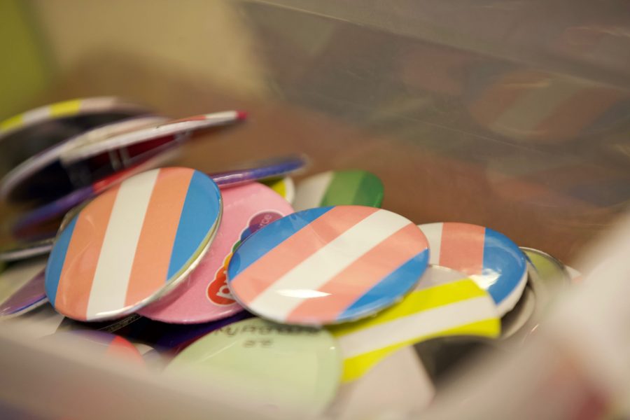Buttons with identity flags in the Pride Resource Center on Oct. 21. Assistant Director Maggie Hendrickson said that “Pride generally provides community building opportunities, advocacy, resources, and education to campus to support queer and trans students.” (Ryan Schmidt | The Collegian)