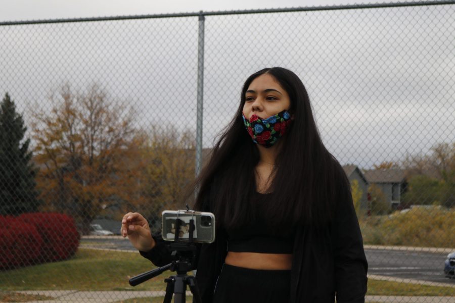 Colorado State University Korean Dance Club member Liliana Zamarripa sets up the tripod before filming a performance at Rams Pointe tennis court Oct. 18. I just always liked [K-pop]. I find it cooler than American music because theres so much more that goes into it, so its more intriguing, Zamarripa said. (Anna von Pechmann | The Collegian) 