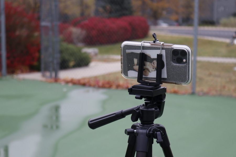 A phone is propped up on a tripod to film the Colorado State University Korean Dance Clubs performance at Rams Pointe tennis court Oct. 18. (Anna von Pechmann | The Collegian) 