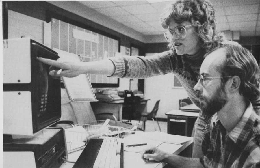 Members of the 1983 Collegian staff work on a computer. (Photo via Silver Spruce)