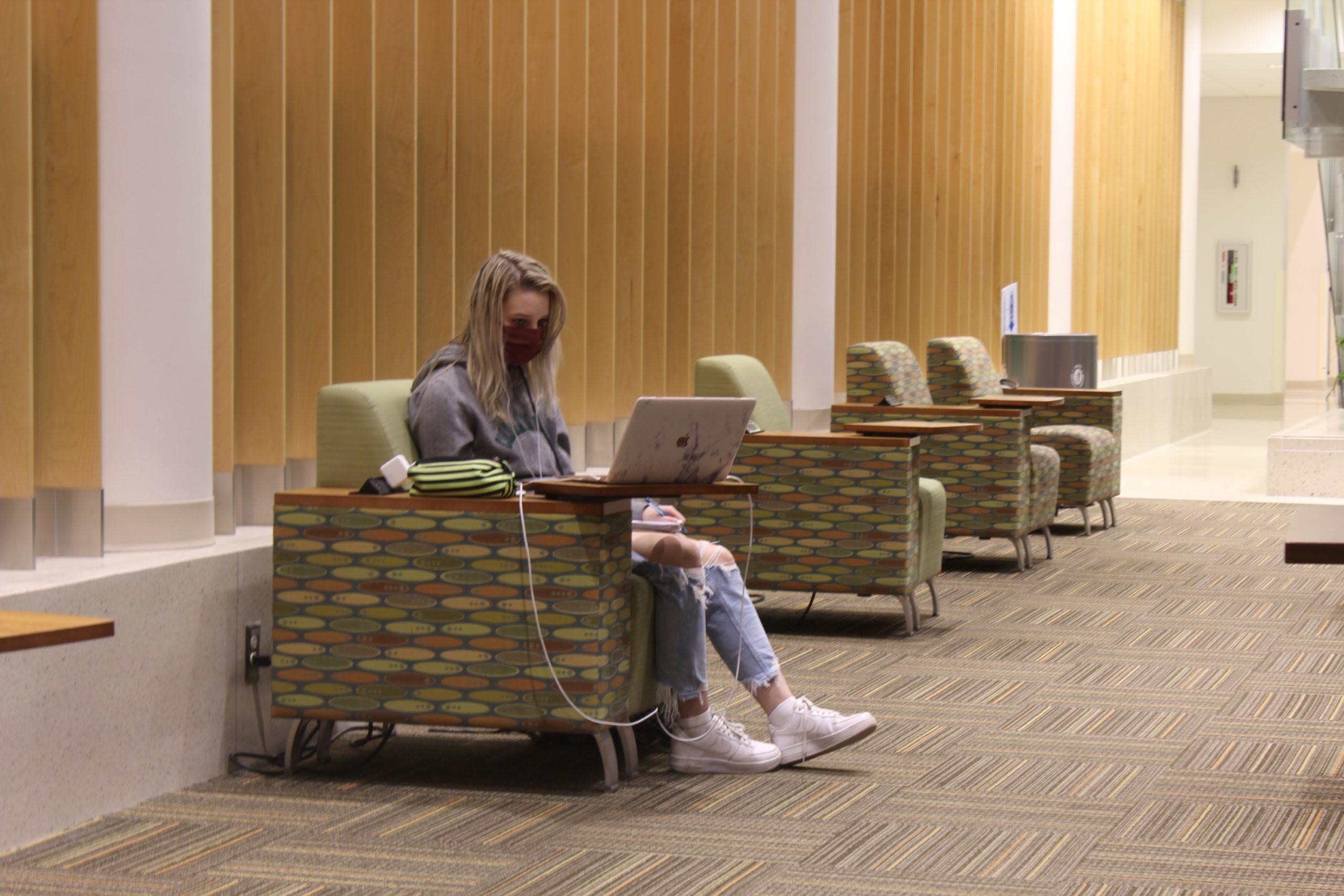 girl sits in the kindness lounge at LSC doing homework