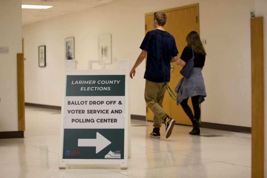 A sign pointing toward a voter service and polling center in the Lory Student Center Nov. 3.  Despite the COVID-19 pandemic, voters were still able to vote in person, and the center featured public health precautions, such as masks and dividers between voters and election judges. (Ryan Schmidt | The Collegian)
