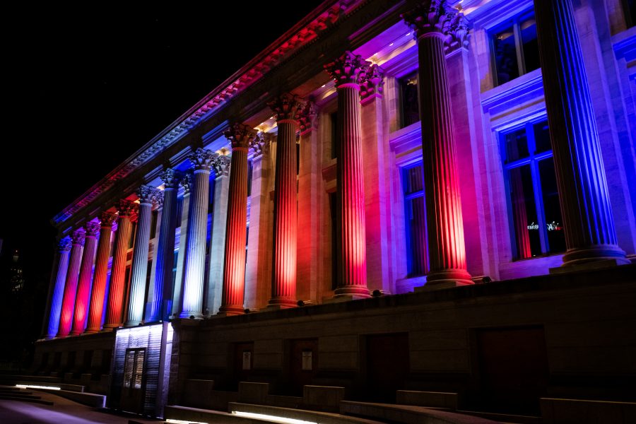 The McNichols Civic Center Building in downtown Denver sits, illluminated in red, white and blue lights. (Lucy Morantz | The Collegian)