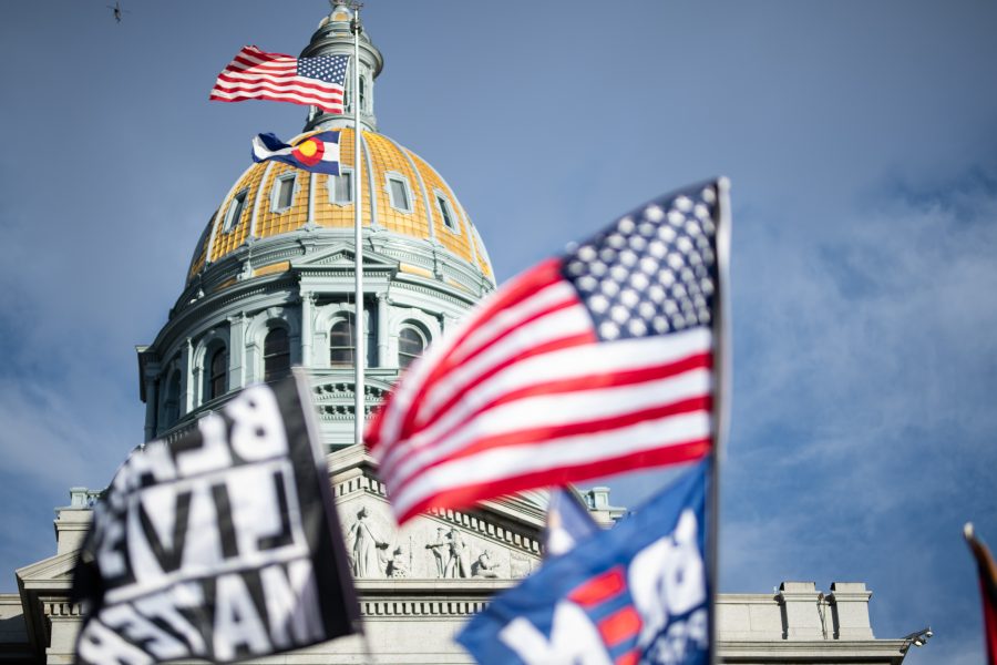 A Black Lives Matter flag, an American flag and a Biden-Harris fly outside the Colorado State Capitol, Nov. 7, 2020. (Lucy Morantz | The Collegian)