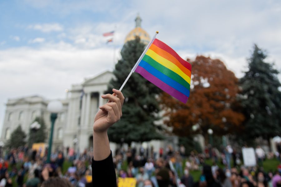 A Joe Biden supporter waves a Pride flag outside the Colorado State Capitol in Denver Nov. 7. (Lucy Morantz | The Collegian)