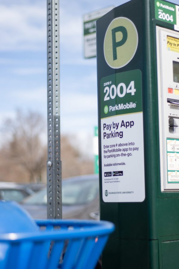 A pay to park station in the Engineering parking lot sits with a sticker for the ParkMobile parking app. The University recently switched from the WayToPark app to the ParkMobile app. (Devin Cornelius | Collegian)
