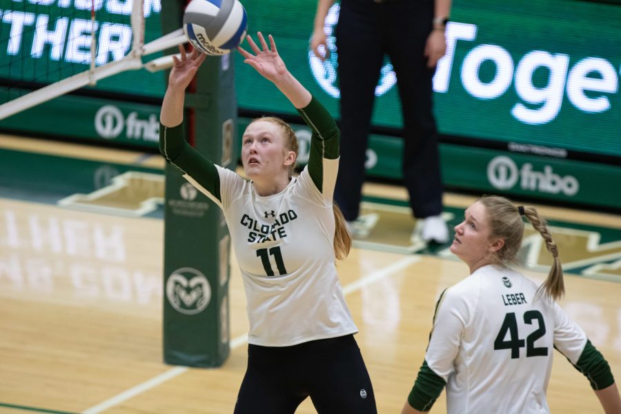 Ciera Zimmerman (11) sets the ball to one of her teammates during Colorado State University’s season opening game against the United States Air Force Academy Feb. 8. CSU defeats Air Force 3-1. (Devin Cornelius | The Collegian) 