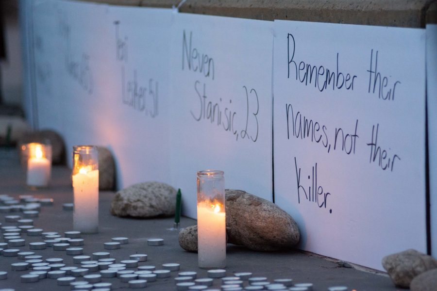Signs listing the names and ages of the victims of the March 22 Boulder King Soopers shooting are placed for a candlelight vigil outside of the Larimer County Justice Center March 23. (Matt Tackett | The Collegian)