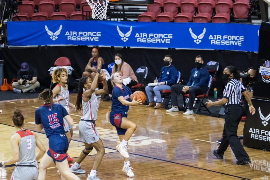 Hanna Cavinder (0) shoots a layup after driving past defenders, during the Air Force Reserve Mountain West Women's basketball tournament Mar. 9. California State University Fresno upset the New Mexico 77-72. (Devin Cornelius | Collegian) 