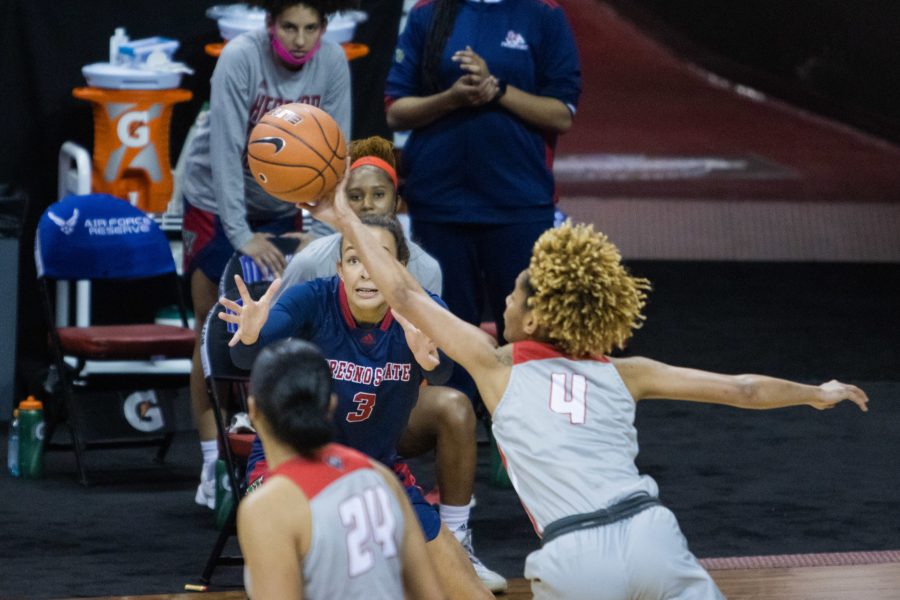 LaTascya Duff (4) swats the ball away from Kendyll Kinzer (3), during the Air Force Reserve Mountain West Women's basketball tournament Mar. 9. California State University Fresno upset the New Mexico 77-72. (Devin Cornelius | Collegian