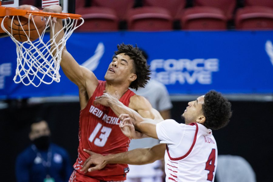 Javonte Johnson (13) dunks on his opponent Junior Ballard (4), during the Air Force Reserve Mountain West men's basketball tournament in Las Vegas.  (Devin Cornelius | Cornelius)