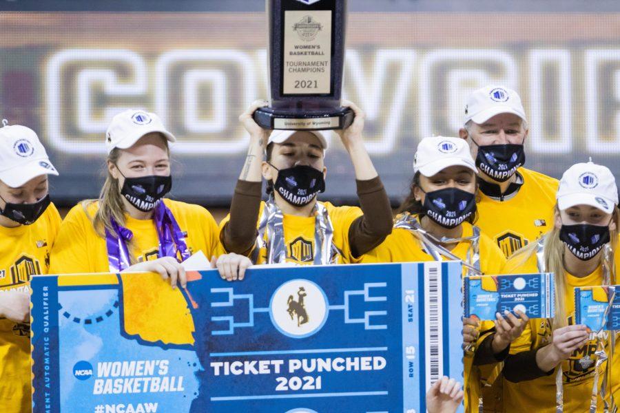 The University of Wyoming Cowgirls celebrate with the Air Force Reserve Mountain West Women's Basketball Championship trophy after taking down California State University, Fresno in the championship game March 11. Wyoming wins 59-56 (Devin Cornelius | Collegian) 