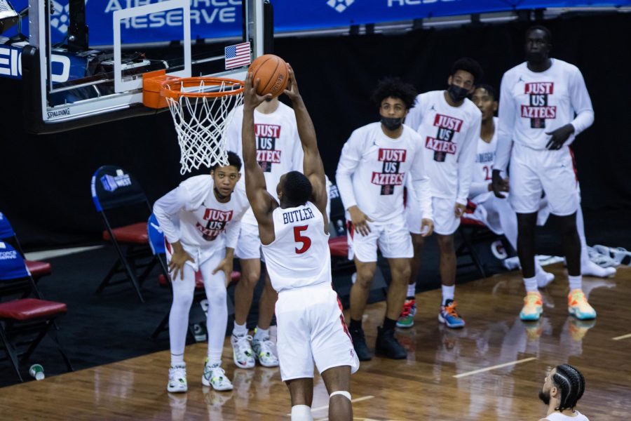 Lamont Butler (5) dunks while his teammates watch after a fast break during the Air Force Reserve Mountain West men's basketball tournament in Las Vegas Nevada. San Diego State University defeats Utah State University 68-57 and become the Mountain West champions. (Devin Cornelius | The Collegian)  