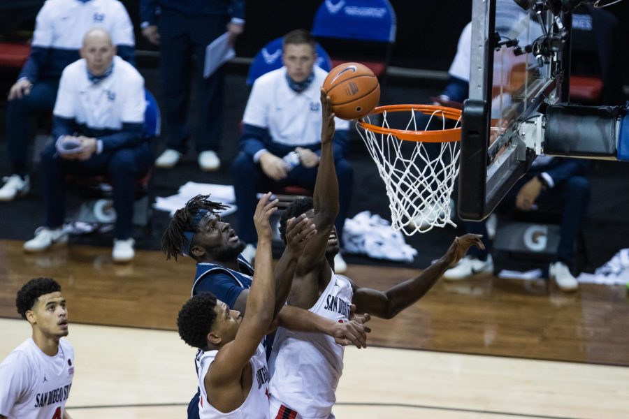 Neemias Queta (23) watches Nathan Mensah (31) block a shot attempt, during the Air Force Reserve Mountain West men's basketball tournament in Las Vegas Nevada. San Diego State University defeats Utah State University 68-57 and become the Mountain West champions. (Devin Cornelius | The Collegian) 