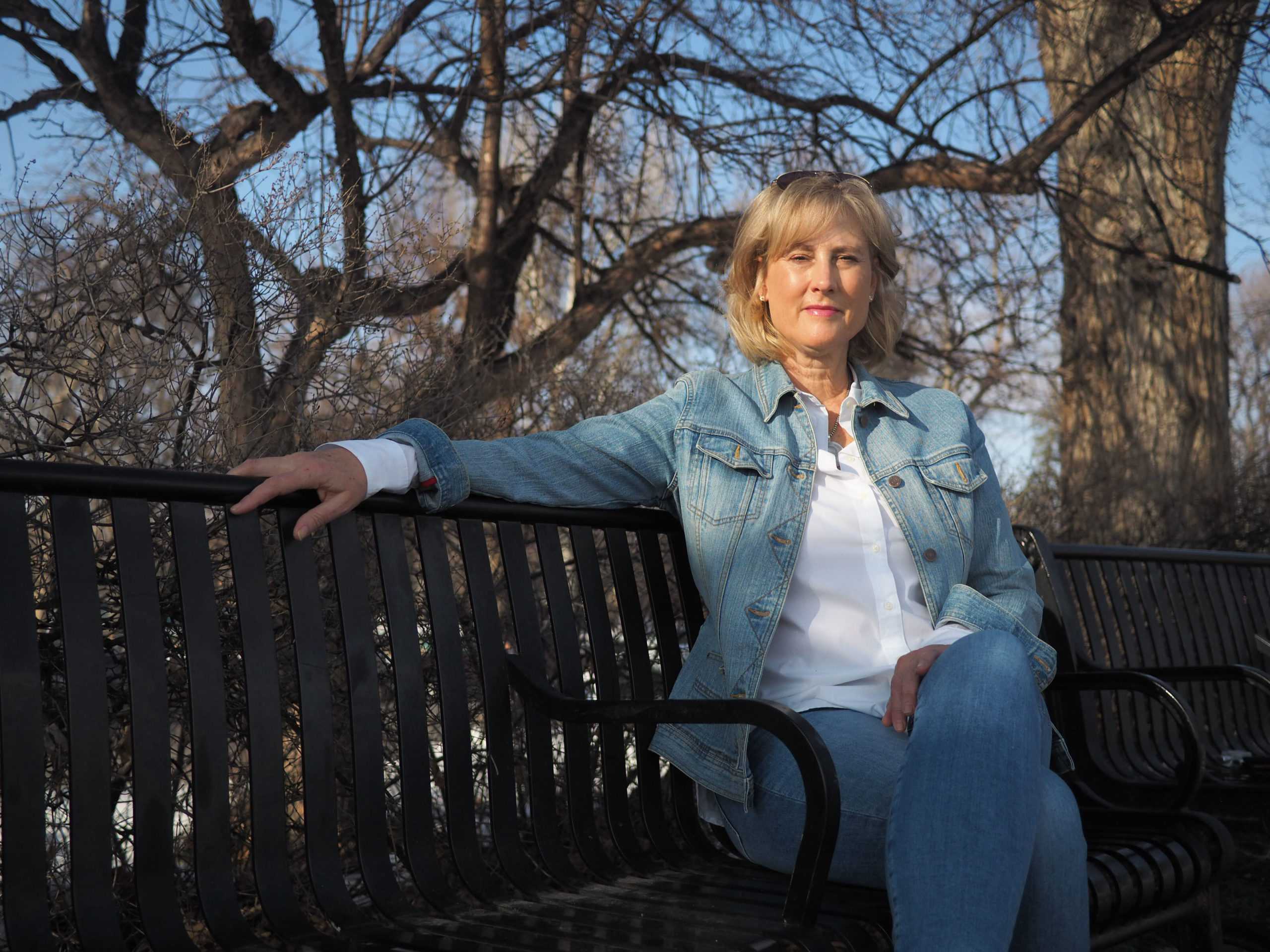 Molly Skold sits on bench in Fort Collins City Park