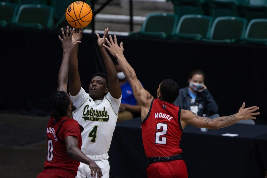 Isaiah Stevens (4) shoots from the three-point line with two defenders on him, during Colorado State University’s basketball game versus North Carolina State University at the National Invitation Tournament in Fresco, Texas in the Comerica Center. Colorado State beat NC State 65-61 March 25. (Devin Cornelius | The Collegian)