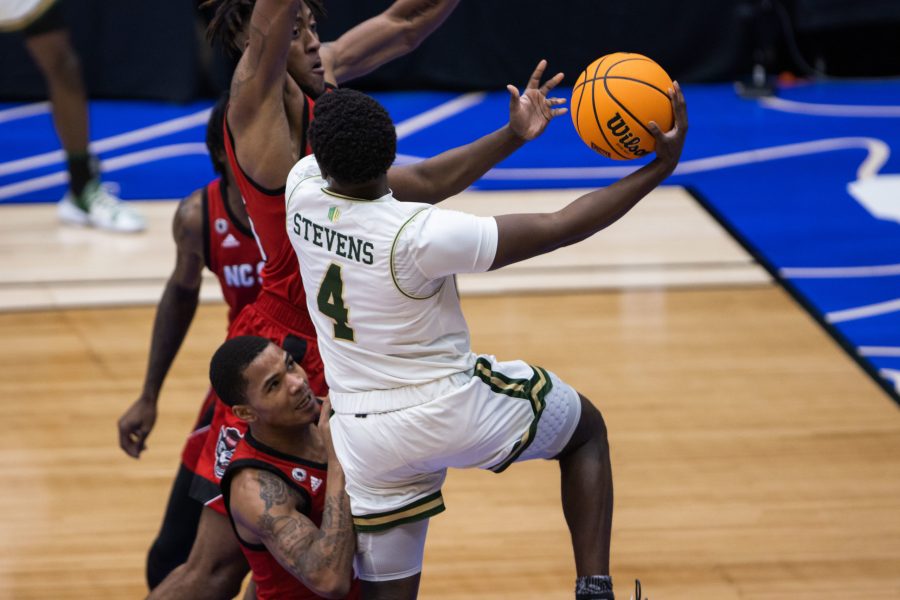 Isaiah Stevens (4) draws defenders into the paint then passes the ball to a teammate during Colorado State University’s basketball game versus North Carolina State University at the National Invitation Tournament in Fresco, Texas in the Comerica Center. Colorado State beat NC State 65-61 March 25. (Devin Cornelius | The Collegian)