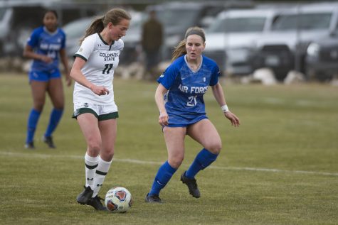Colorado State midfielder Kaitlyn Abrams (11) dribbles the ball past Air Force Academy defender Alex Giggle in the Rams 1-0 win over the visiting Falcons on March 26. (Gregory James | The Collegian)