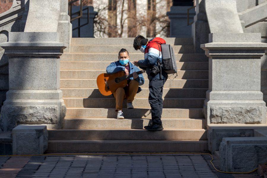 Ben Nguyen talks to photojournalist Akash Parmathy at a protest at the Colorado State Capitol March 27. Nguyen later performed a song about the pain of losing a loved one. (Michael Marquardt | The Collegian)
