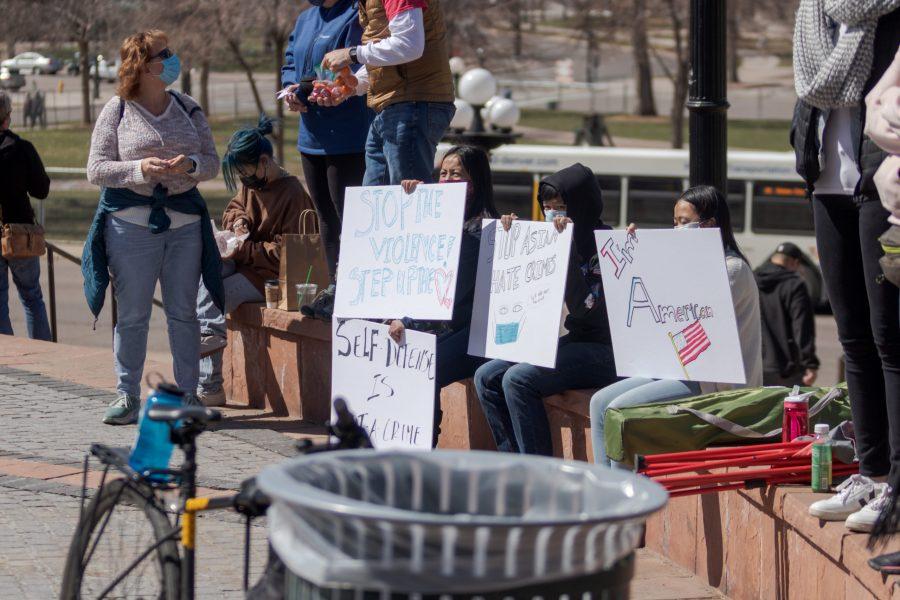 Protesters hold signs outside the Colorado State Capitol March 27. The protest featured speeches, poetry, and music from the Asian-American and Pacific Islander community. (Michael Marquardt | The Collegian)