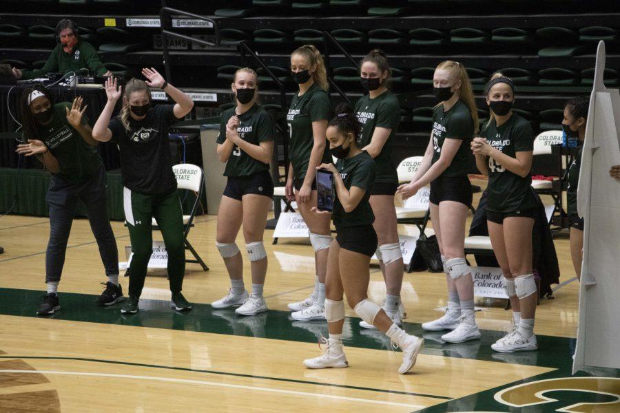 Colorado State University volleyball player Brooke Hudson walks down the line of players holding an iPad with senior Breanna Runnels on Facetime at the last home game of the season March 27. Before the game started, the team had a ceremony for the two seniors on the team. (Anna von Pechmann | The Collegian) 