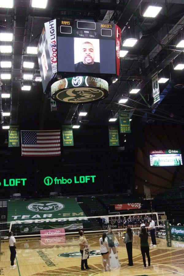 Colorado State University Head Coach Tom Hilbert, senior player Alexa Roumeliotis, Associate Head Coach Emily Kohan and Assistant Coach Adrianna Blackman look up at the big screen as a video of senior player Breana Runnels loved ones congratulating her plays in Moby Arena March 27. Blackman (right) holds the iPad up towards the screen so Runnels can be part of the ceremony virtually, and they have a cardboard cut-out of her in her place. (Anna von Pechmann | The Collegian) 