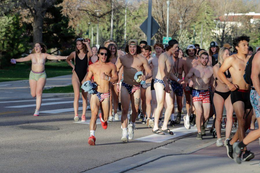 A crowd runs past the Colorado State University Transit Center during the Undie Run May 1. (Michael Marquardt | The Collegian)