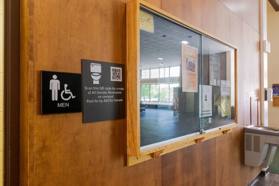 A sign with a QR code linking to a map of All Gender Restrooms is seen in the Clark building Aug. 25. (Michael Marquardt | The Collegian)