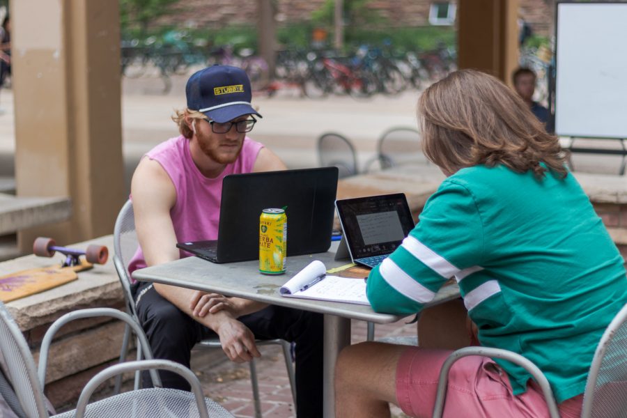 (Left to right) Noah Smith and Samuel Downs study outside the Clark building Aug. 30. (Michael Marquardt | The Collegian)