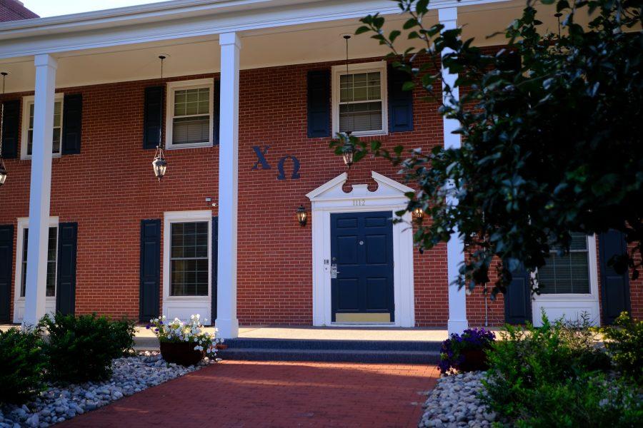The Chi Omega house sits in the sun, while the letters are displayed prominently above the front door. (Tri Duong | The Collegian)