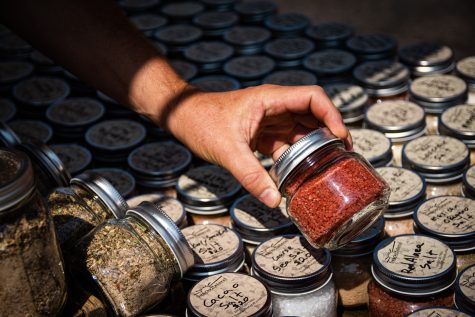 hand holding jar of spices