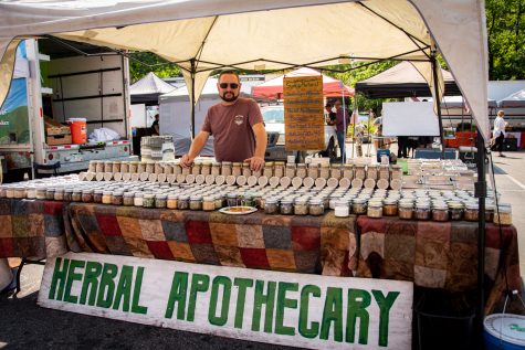 Josh Hillhouse, owner of Herbal Apothecary, waits for customers to come by at his booth at the Larimer County Farmers Market in Fort Collins, Colorado Sept. 5. Hillhouse has a collection of spices that can be used for cooking as well as brewing tea. (Tri Duong | The Collegian)