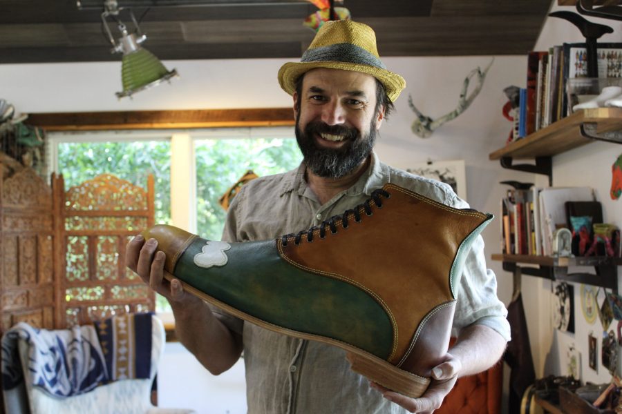 Dan Huling, owner of the Colorado Shoe School, holds one of the largest shoes hes ever made Sept. 7, 2021. The Colorado Shoe School was created in 2018 by Huling and Annabel Reader. The school, located in Bellvue, Colorado, has a workspace to create different kinds of footwear. Huling made this particular shoe for a parade that took place. The tallest man in the world can actually fit into this shoe, he said. 
