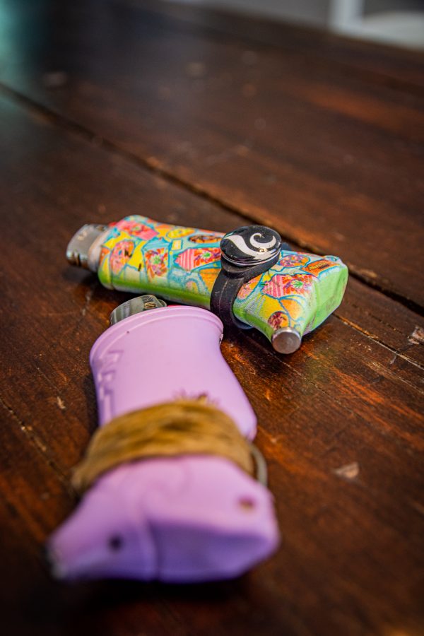 Photo illustration of lighters wrapped with hemp wick and charms that can improve the efficiency and cleanliness of a smoke session Sept. 14. (Tri Duong | The Collegian)